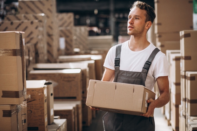 young-man-working-warehouse-with-boxes_1303-16606
